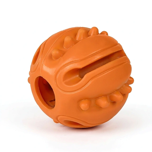 Studio packshot of an orange rubber treat dispensing dog chew ball - rubber treat dispensing chew ball with dental nubs - dog puzzle toys wholesale supplier