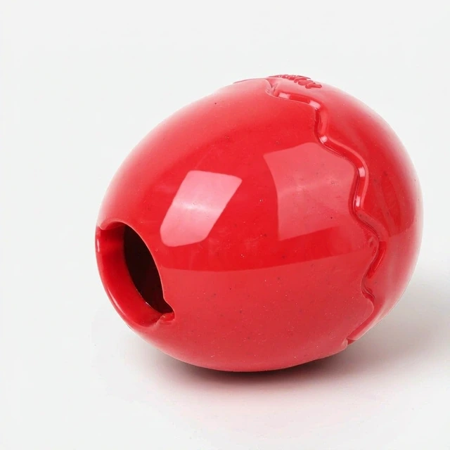 Studio packshot of a glossy red egg shaped dog treat dispensing ball - glossy egg shaped treat dispensing ball for dogs - durable dog toys wholesale supplier