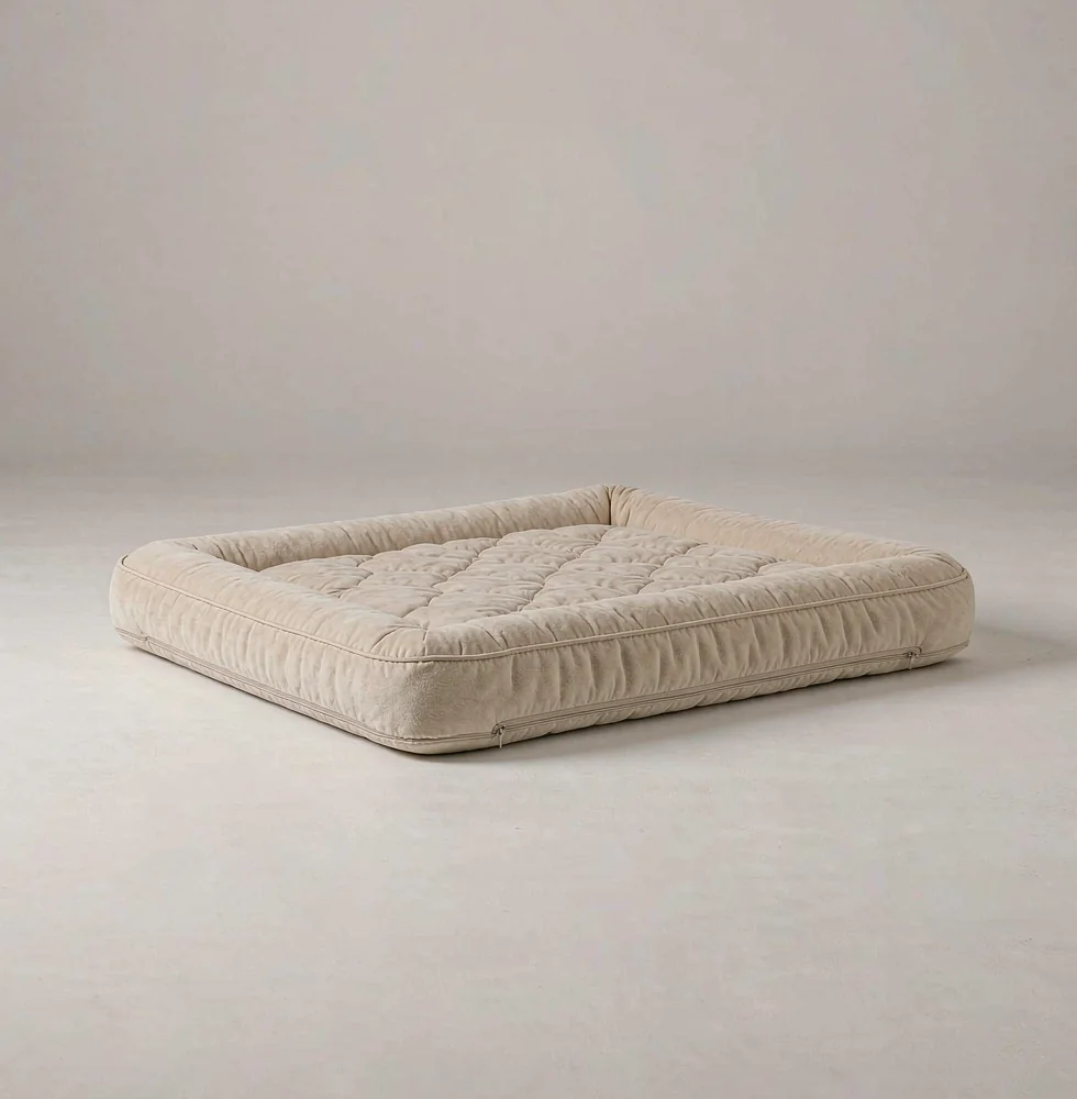 Orthopedic memory foam pet bed with a bolstered rim and a quilted removable cover