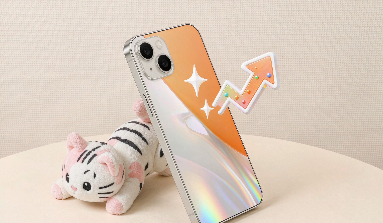 Smartphone with sparkle and upward trend arrow graphics beside a plush cat toy
